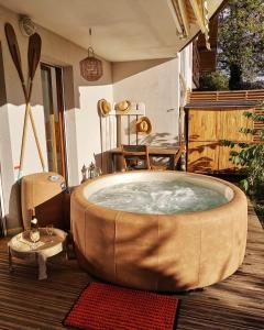 a large tub in the middle of a room at ** Nouveau ** Le Jardin De La Plage - Appartement avec extérieur in Saint-Jorioz