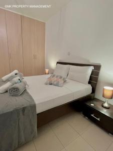 a bedroom with a large bed with white sheets at City Flats Apt.C307 in Larnaca +46 photos