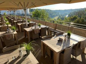 a restaurant with tables and chairs on a balcony at Gasthof Rabenwirt in Pullach im Isartal