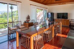a dining room with a table and chairs at Ayara Villa 3 - Unique Gem with Private Pool and Majestic Sea Views in Amphoe Thalang