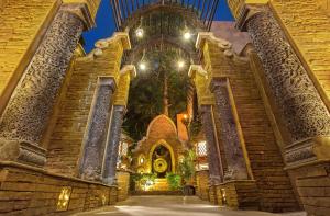 an entrance to a church with a large building at Sawasdee Village in Kata Beach