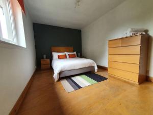 ein Schlafzimmer mit einem Bett und einer Kommode darin in der Unterkunft 2 Bedroom, free parking & Netflix near hospitals in Aberdeen