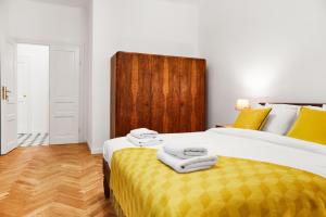 a bedroom with two beds and a wooden headboard at HOUSEHOST Apartment :Starowiślna 66/9 Street in Kraków