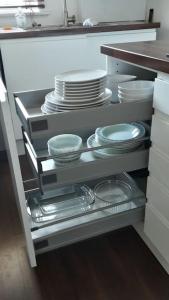 a kitchen with plates and dishes on a shelf at 2 Bedroom, free parking & Netflix near hospitals in Aberdeen
