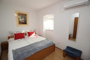 sypialnia z łóżkiem i niebieskim krzesłem w obiekcie Apartment Milijana w mieście Punat