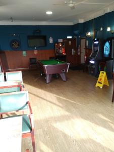 a room with a pool table and arcade games at Ravenswood Social Club in Banchory
