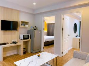 a hotel room with a living room with a bed at Miloft Sathorn Hotel - SHA Plus Certified in Bangkok