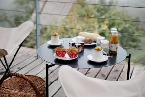 a table with muffins and drinks on a balcony at LILELO - Little Leisure Lodge in Grazzano Badoglio