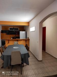 a room with a table and chairs and a kitchen at Appartement de 3 chambres a Le Moule a 800 m de la plage avec piscine partagee et jardin clos in Le Moule