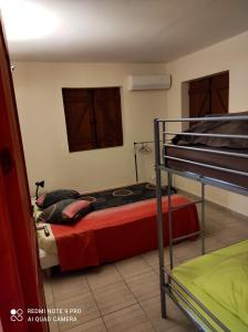 a bedroom with two bunk beds in a room at Appartement de 3 chambres a Le Moule a 800 m de la plage avec piscine partagee et jardin clos in Le Moule