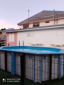 a swimming pool in front of a building at Appartement de 3 chambres a Le Moule a 800 m de la plage avec piscine partagee et jardin clos in Le Moule