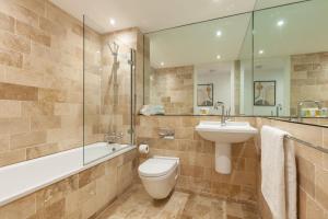 a bathroom with a toilet and a sink and a tub at The Sinclair Building in Sheffield +37 photos