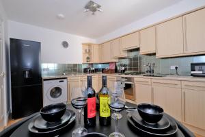 a kitchen with two bottles of wine on a table at Orange Apartments Beechgrove Gardens in Aberdeen