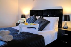 ein Schlafzimmer mit einem Bett und einem Tablett mit Essen drauf in der Unterkunft Orange Apartments Beechgrove Gardens in Aberdeen