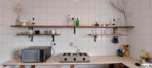 a kitchen with a stove and a microwave at The white villas (TWV) in Ras Sedr