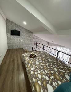 a bedroom with a large bed in the middle of a room at Big and comfortable apartment in Chişinău