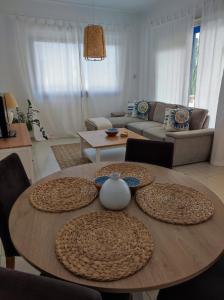 uma sala de estar com duas mesas e um sofá em Marina Gardens em Pafos