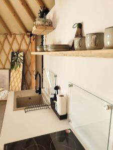 a kitchen with a sink and a counter top at Hoya Glamping in Gostynin