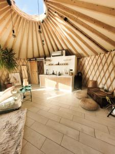 a room with a yurt with a table and a couch at Hoya Glamping in Gostynin