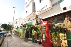 a red phone booth in front of a building at EAST WEST HOTEL in Casablanca