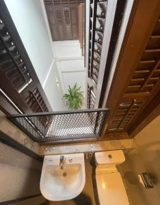 a bathroom with a sink and a toilet at The Magazine Boutique Hotel in George Town