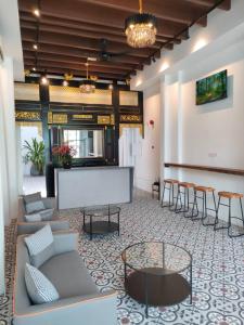 a lobby with couches and a table and chairs at The Magazine Boutique Hotel in George Town