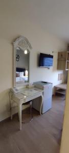 a desk with a mirror in a room at Layaali Amman Hotel in Amman