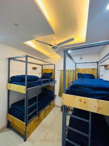 two bunk beds in a room with a ceiling at Skyard Premium, Tapovan in Rishīkesh