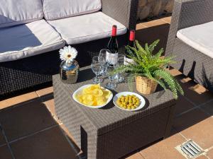 a table with two bowls of fruit and wine glasses at Villa Sitges Soledad 15 minutes drive from Sitges XXL swimming pool 12 p in Olivella