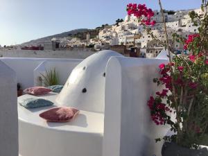 a table with pillows on a balcony with flowers at Riad Aziman in Tetouan