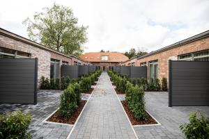 uma linha de plantas no pátio de um edifício em City Housing Genk em Genk