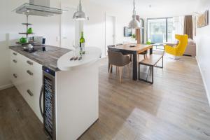 a kitchen and dining room with a dining table at Passepartout in Norderney