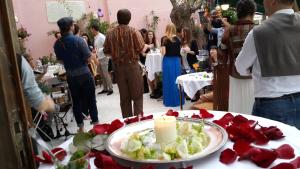 a group of people standing around a table with a candle at Büyükada Anastasia Meziki History Mansion in Buyukada