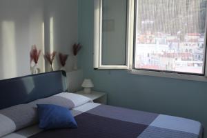 a bedroom with a bed and a window with a view at Casa Azzurra in Cetara