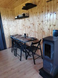 a dining room with a table and a stove at Zážitkový pobyt uprostřed přírody in Železný Brod