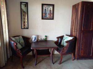 a table and two chairs in a room at Okutala Etosha Lodge in Outjo