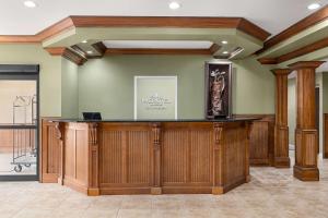 a lobby with a wooden bar in a building at Microtel Inn & Suites by Wyndham Woodstock/Atlanta North in Woodstock