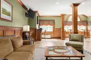 a living room with a couch and a table at Microtel Inn & Suites by Wyndham Woodstock/Atlanta North in Woodstock