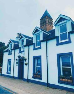a blue and white building with a clock tower at This must be the place - Arran, Lamlash in Lamlash