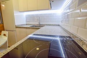 a kitchen with a sink and a counter top at Letmalaga Square Merced in Málaga