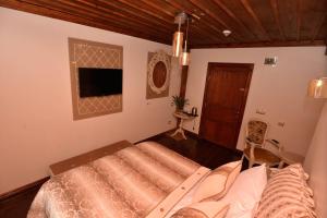 a bedroom with a bed and a tv in it at Arasta Konak Otel in Eskisehir