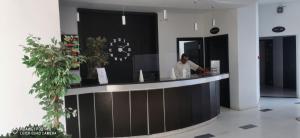 a man standing at a counter in a lobby at HOTEL OLYMPIC DJERBA in Djerba