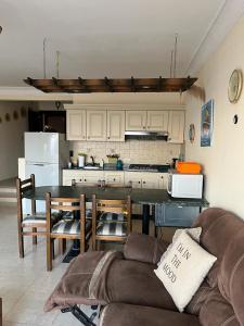 a living room with a table and a kitchen at LA VISTA Ain Elsokhna 1&2 Chalet in Ain Sokhna