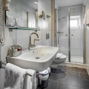 a bathroom with a sink and a toilet and a shower at Gasthaus zum Kranz in Lörrach