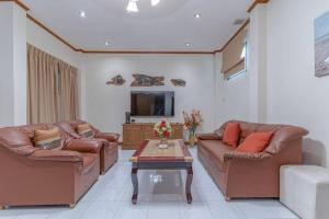 un salon avec deux canapés et une table basse dans l'établissement Resort 5-3BR Huge Pool, BBQ, 300m-Beach, 8 mins to Walking Street, à Pattaya (sud)