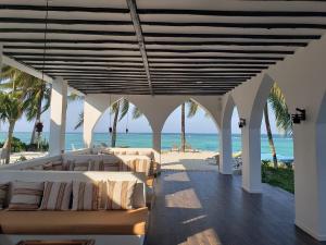 a bedroom with a view of the beach at Shooting Star Boutique Hotel in Kiwengwa