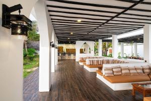 a lobby with couches and tables in a building at Shooting Star Boutique Hotel in Kiwengwa