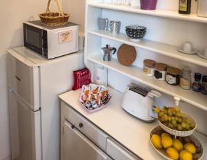 - un comptoir de cuisine avec un four micro-ondes et une corbeille de fruits dans l'établissement Thalassa Apartment with AC, Terrace and Views, à Vernazza