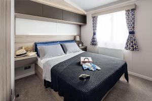 ein Schlafzimmer mit einem Bett mit Hut darauf in der Unterkunft Machrihanish Holiday Park in Campbeltown