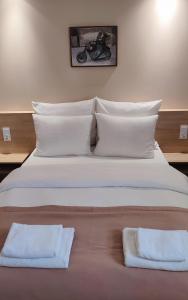 Łóżko lub łóżka w pokoju w obiekcie Hotel Gem